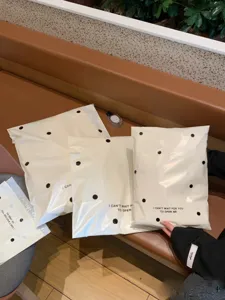 Milk white polka dot courier bag, thickened waterproof mailing bag for stylish clothing packaging.