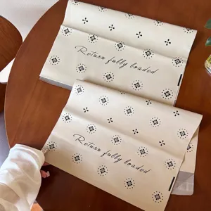 Detail shot of thickened waterproof self-adhesive mailing bags in beige with floral print and text.