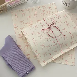INS style kraft paper gift bags with cute bow print and red white twine rope packaging.