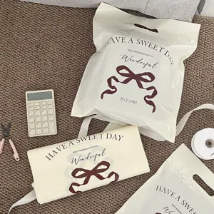 Detailed close-up of the waterproof plastic packaging bag with cute bow and sweet text print.