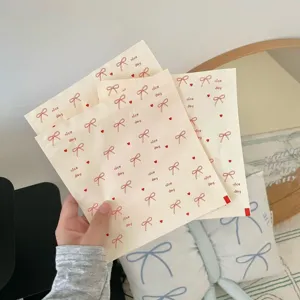 Cute bow print paper gift bags, ideal for birthday party favors and holiday packing.