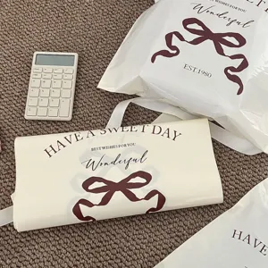 Thickened waterproof plastic courier bags with bow prints and English text for clothing shipping.