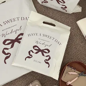 Detail shot of thickened waterproof plastic courier bags featuring an elegant bow design.