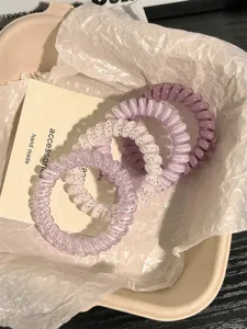 Detailed view of cute Korean style telephone wire hair ties in sweet purple and polka dot colors.