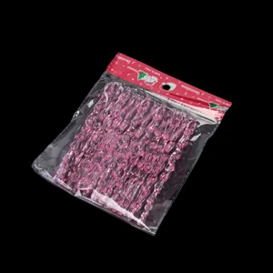 Detailed view of pink acrylic icicle hanging decorations, clear holiday party decor.