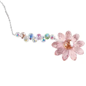 Detailed close-up of crystal flower suncatcher pendant featuring pink crystals and colorful beads.