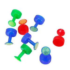 Detailed view of colorful plastic bottle cap watering sprinklers for garden plants.