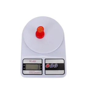 Red plastic watering sprinkler head detail, compact size for potted plants and garden care.
