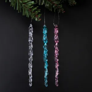 Detailed close-up of colorful acrylic icicle ornaments hanging on pine branch for decor.