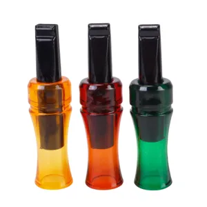 Detail view of colorful plastic crow call whistles for outdoor hunting and decoy use.