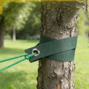 Green tree staking straps detail shot showing durable webbing and metal grommet fixation.