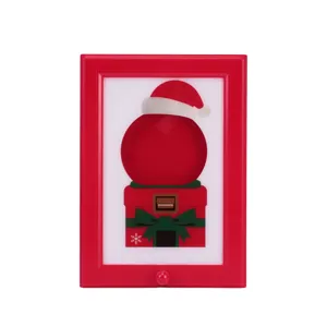 Distributeur de bonbons cadre photo rouge avec motif cadeau de Noël pour la décoration de fête.