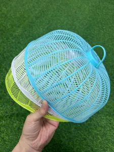 Detail view of colorful plastic mesh food covers, stackable design for easy home kitchen storage.