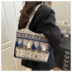 Ethnic style woven tote bag with chic tassels and striped pattern for women travel street.