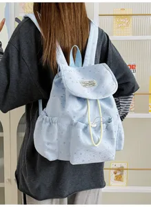 Detailed view of a sweet Japanese style light blue star print canvas drawstring backpack.