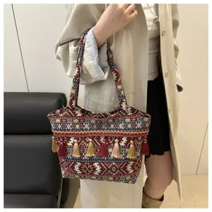 Ethnic style tassel striped tote bag detail, featuring geometric woven pattern and shoulder straps.