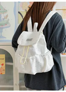 Japanese sweet style white star print canvas backpack with cute drawstring and front pockets.