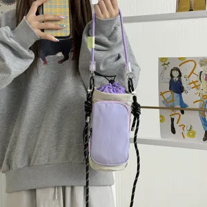 Close-up detail of lightweight drawstring water bottle bag with stylish color-blocking.