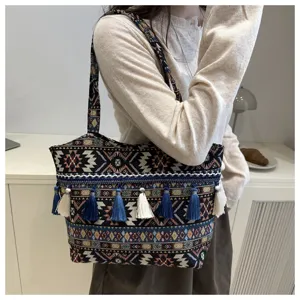 Ethnic style woven striped tote bag with tassels, fashionable shoulder bag for travel street style.