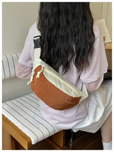 Detail view of color-blocked crossbody chest bag, casual style with adjustable strap and zip pocket
