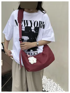 Korean style minimalist solid color nylon women's shoulder crossbody bag detail view.