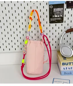 Detailed view of colorful strap pink drawstring crossbody phone bag and water bottle carrier.
