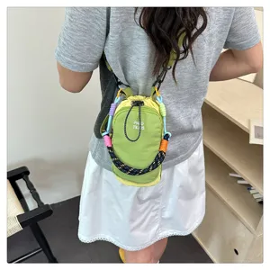 Green mini crossbody phone bag with colorful braided strap and convenient drawstring closure.