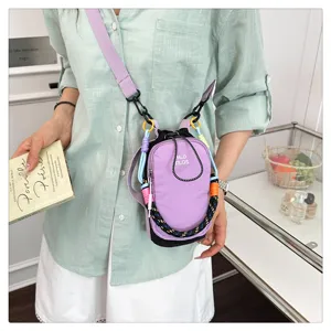 Chic purple mini crossbody phone bag with colorful woven strap, trendy fashion design.