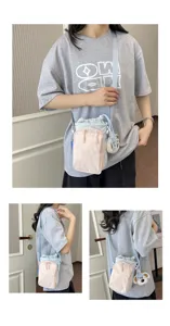 Korean dopamine color-blocking canvas crossbody phone bag with cute dog pendant and front pocket.