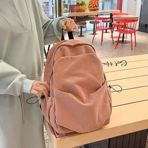 Vintage corduroy backpack for women, casual pink school bookbag with pockets and stylish design.