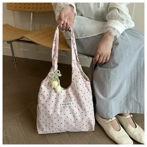 Summer new pink polka dot canvas tote bag with cute flower and pearl charm decoration detail.