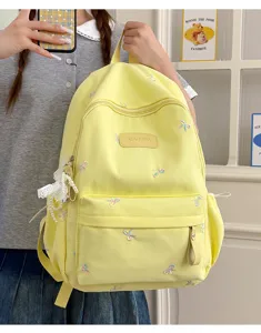 Sweet bow embroidered yellow student backpack, stylish large capacity casual daypack.