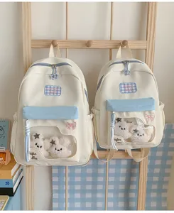 Süßer, farbiger Schüler-Rucksack mit transparentem Fach und Plüschtier-Anhänger.