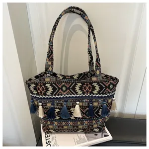 Ethnic style striped tote bag with colorful tassels, fashionable woven shoulder bag for daily travel.