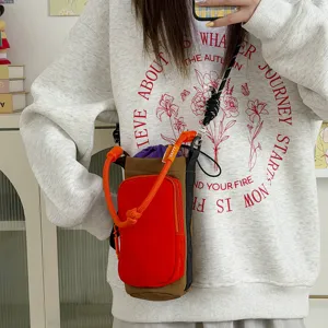 Close-up detail of outdoor sports color-block crossbody phone and water bottle bag strap.