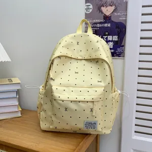 Charmant sac à dos décontracté à pois jaunes pour filles, léger et grande capacité.