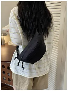 Casual black crossbody chest bag for women, stylish fanny pack with zipper and adjustable strap.