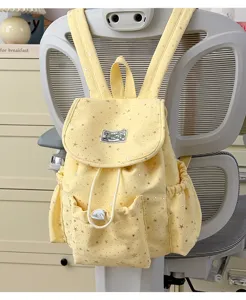 Sweet Japanese style yellow canvas backpack detail featuring silver stars and front pocket.