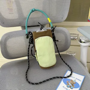 Outdoor sports drawstring crossbody bag with green handle and phone pocket for daily travel.