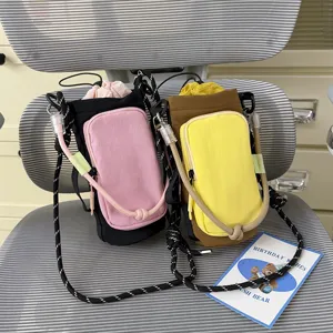 Versatile color-block crossbody water bottle bag with drawstring pocket for outdoor sports.