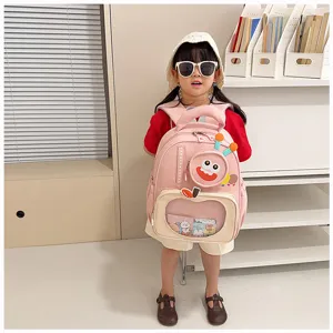Cute cartoon pink backpack with transparent front pocket and fun monster design for kids.