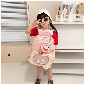Cute pink kids backpack detail featuring a fun cartoon monster pocket and front display window.