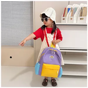 Cute kids color-block school backpack with front pocket, stylish and durable travel bag.