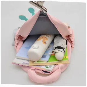 Detailed view of the cute pink kids school backpack showcasing spacious interior capacity.