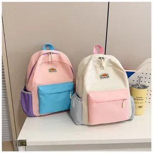 Colorful kids backpack for school and travel, cute color-blocking design with front pocket.