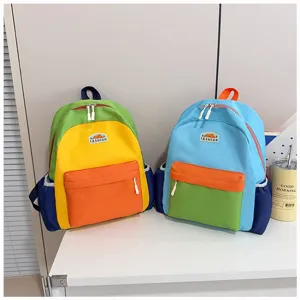 Children color-blocking school backpack detail shot, multi-compartment casual daypack.