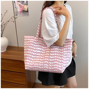 Detailed view of the stylish pink and white wave printed canvas tote bag showcasing large capacity.