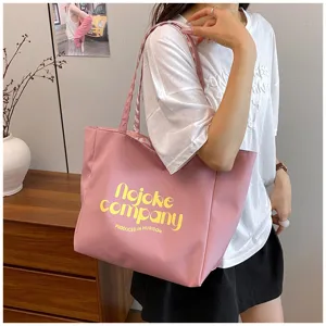 Pink nylon tote bag for women, large capacity casual shoulder bag with letter print design.