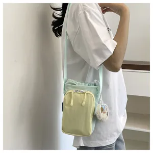 Korean dopamine color-blocking crossbody phone bag featuring a cute plush pendant detail.
