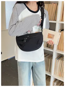 Casual black nylon cross-body dumpling bag featuring a sleek crescent design and zipper.